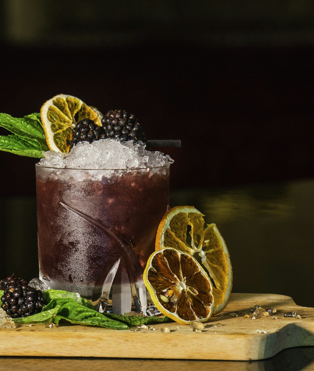 Hand-finished cocktail garnished and served on a dark bar top